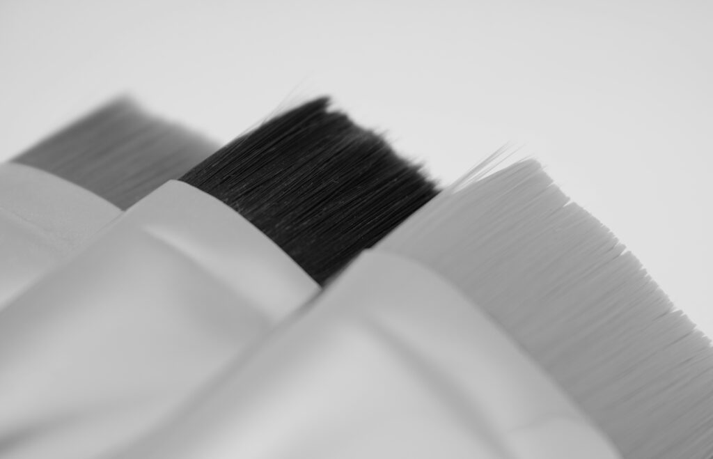 Using detailing brushes for hard-to-reach car areas.