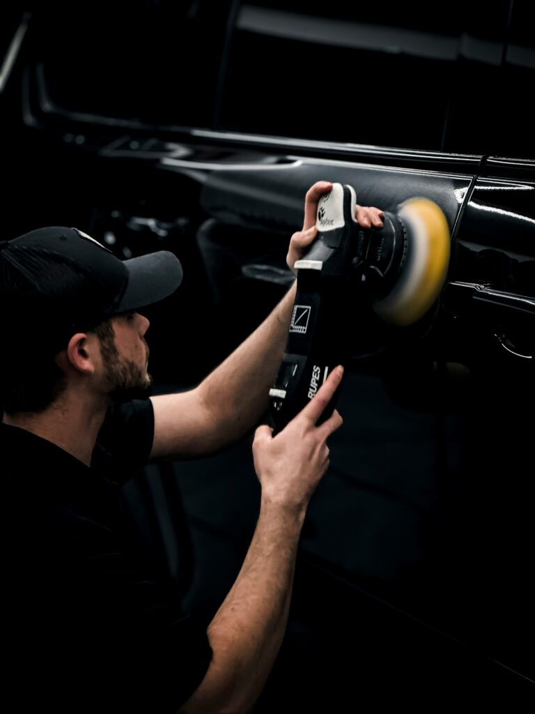 Using a Shine Mate Dual-Action Polisher to achieve a smooth car finish.